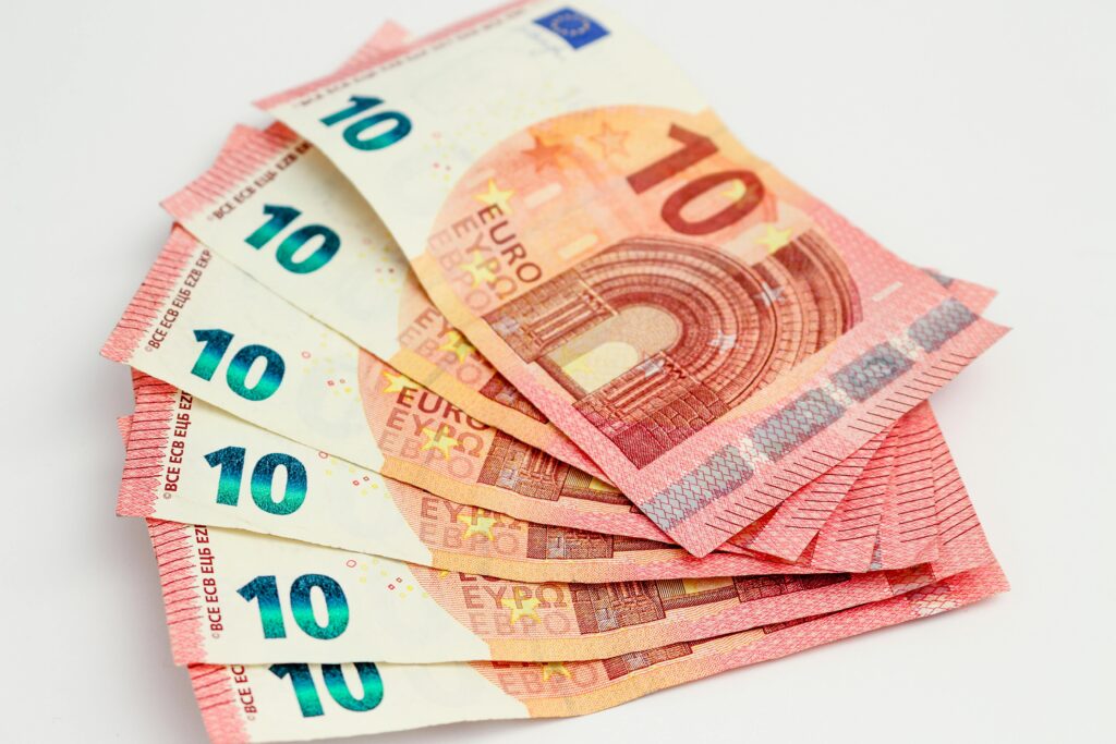 Close-up of a fan of 10 euro banknotes on a clean white background, showcasing European currency.